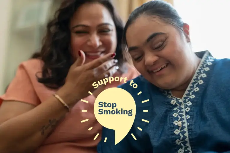 Carer with patient, sat smiling together
