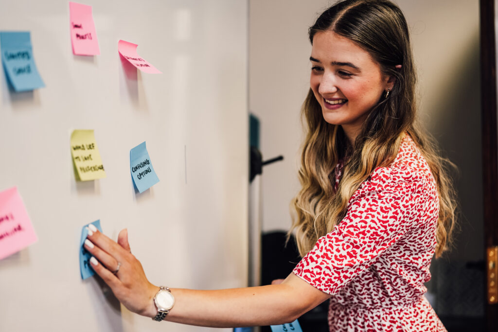 Employee planning with post its on a whiteboard